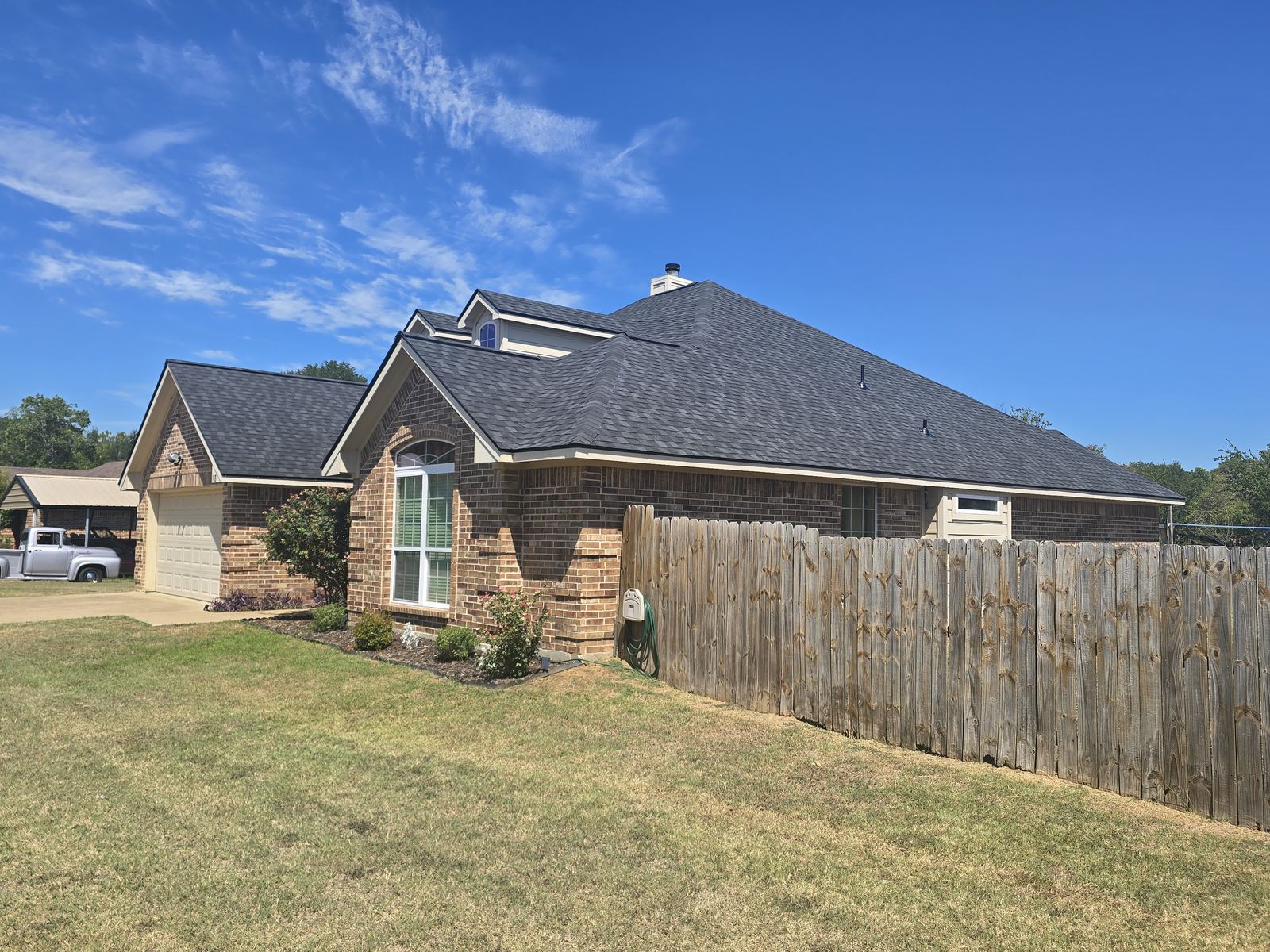 Brick home with new shingle roof in East Texas